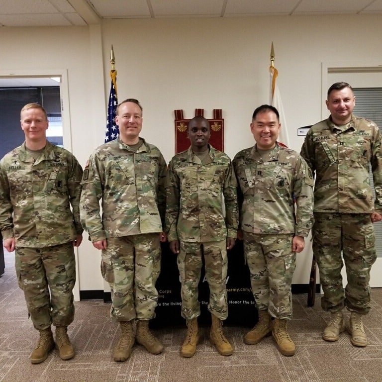 US Army Chaplain Assistant Cosmas Cheseret with Army coworkers